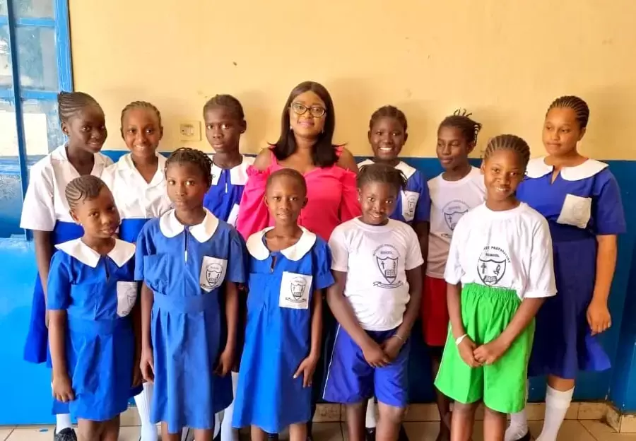group of gambian girls students in school with charity champion
