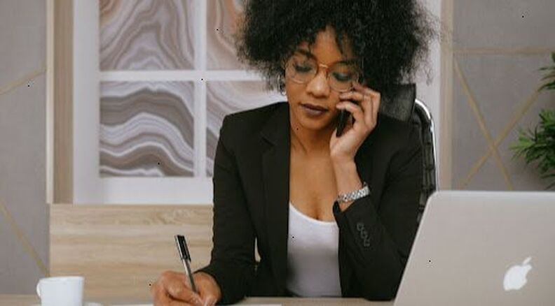 black business woman in office talking to the phone