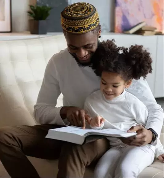 Black Father reading with daughter 
