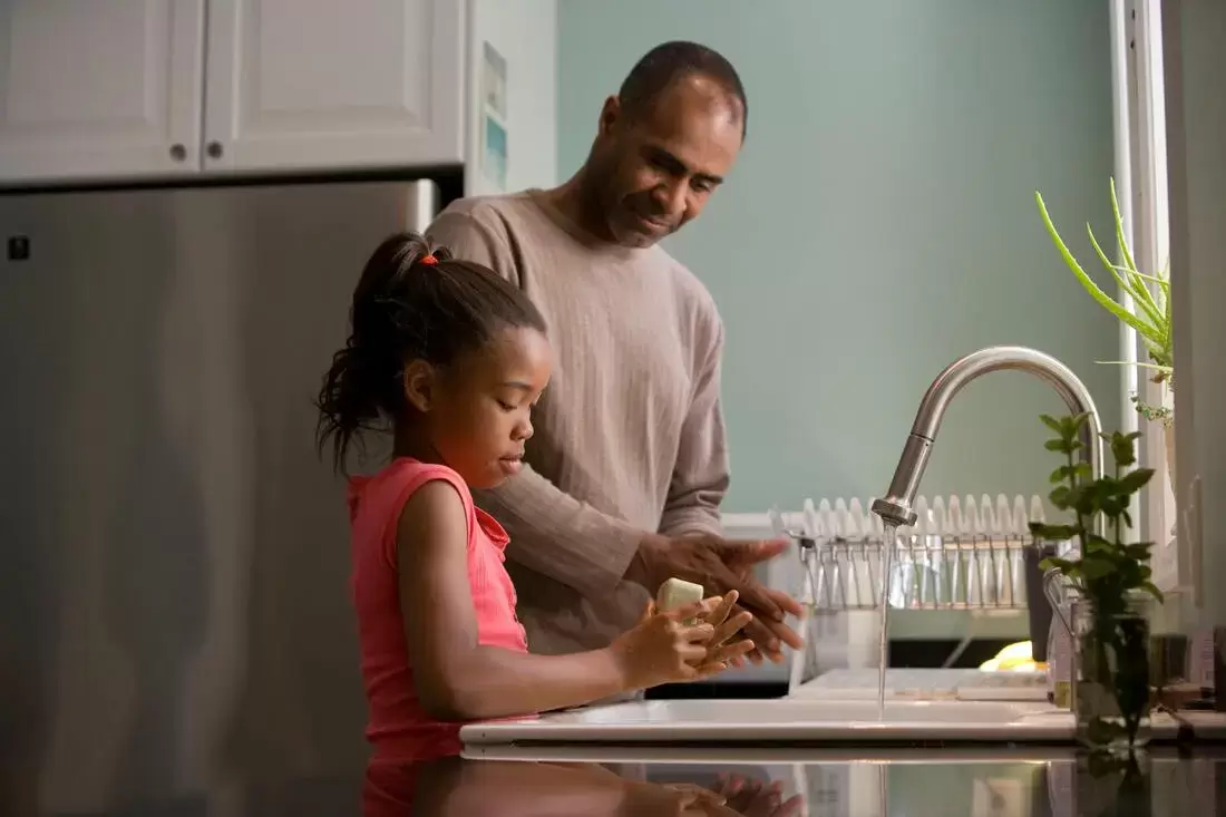 Black Father and Daughter Washing Hands 